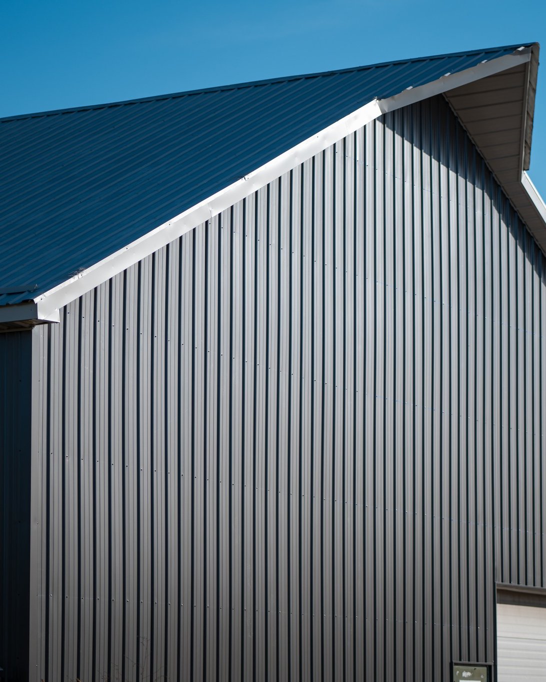 MP36 steel siding charcoal Farm building with charcoal MP36 steel siding, designed for rugged agricultural performance