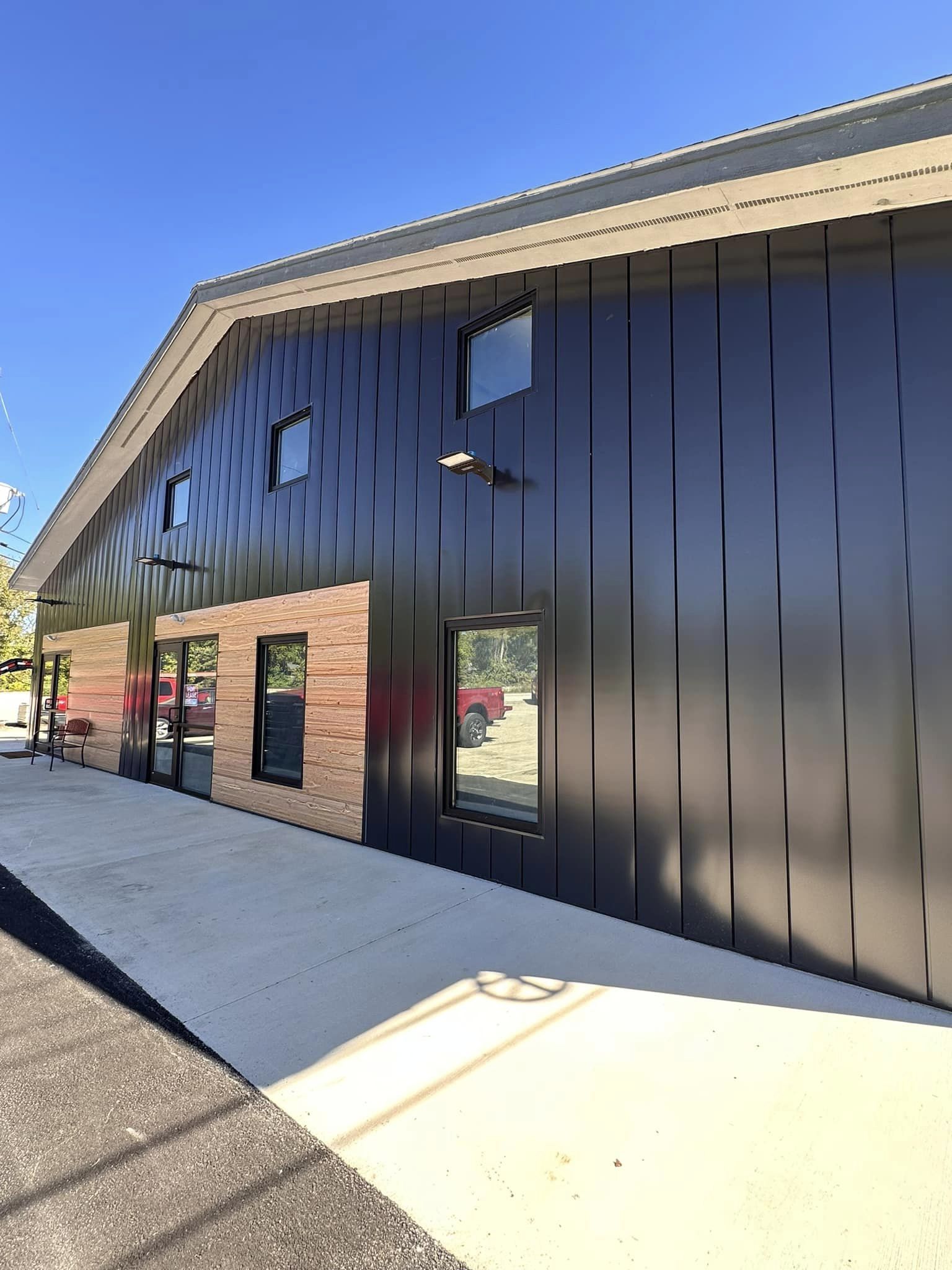 flush-front Modern commercial building with black and cedar flush front steel siding panels