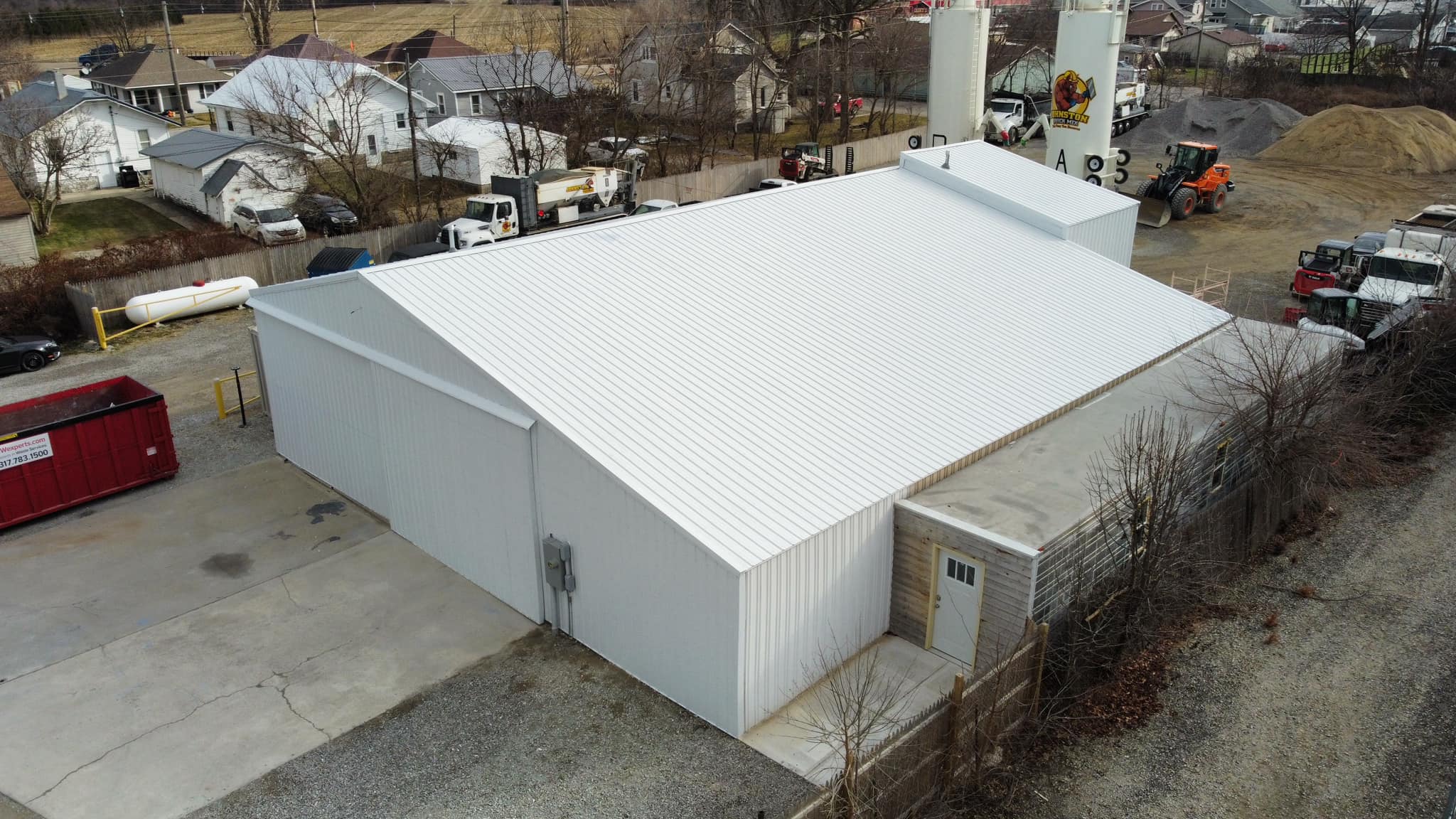 MP36steel siding white Commercial building clad in white MP36 steel siding panels, showcasing clean, low-maintenance exterior